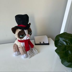 Grumpy Cat plush toy in a fancy hat and scarf